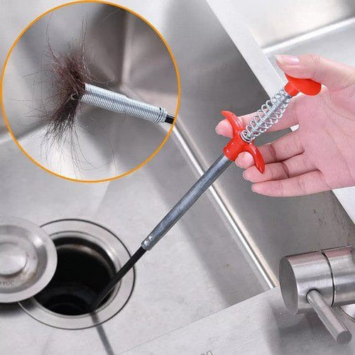 Plumbing tool being used to clear a drain with hair buildup.